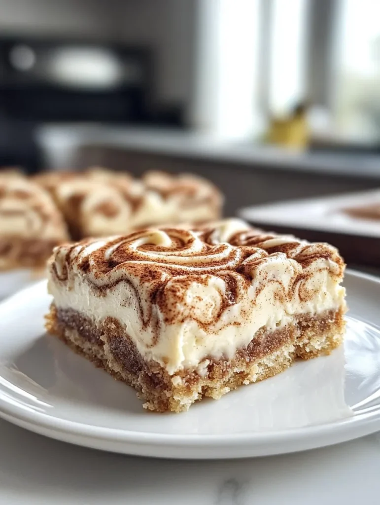 Sliced Cinnamon Roll Cheesecake Bars on a white plate with a fork
