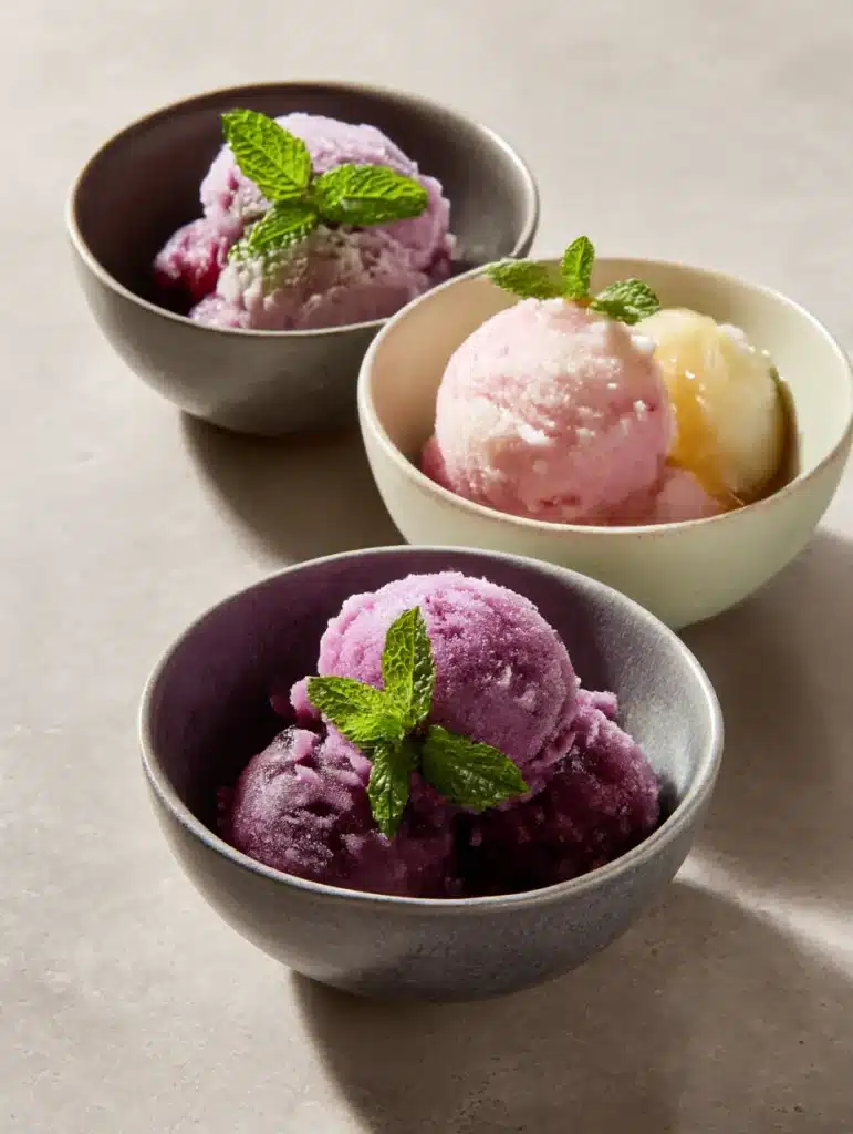 Homemade grape sorbet variations with mint and honey in simple kitchen bowls